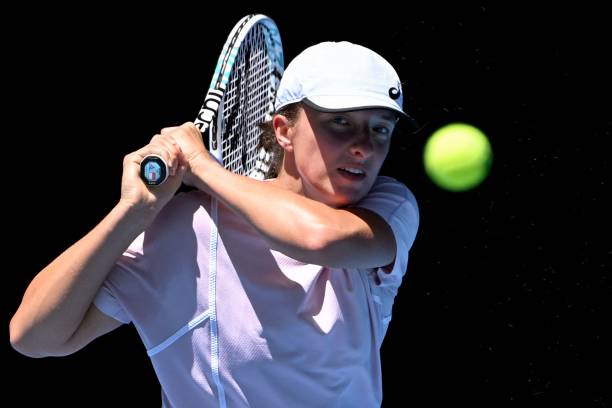 Poland's Iga Swiatek hits a return during a practice session ahead of the Australian Open tennis tournament in Melbourne on January 11, 2023. - --...