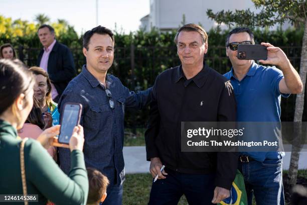 Former Brazilian president Jair Bolsonaro greets supporters outside the home where hes staying in a resort community near Disney World in Kissimmee,...