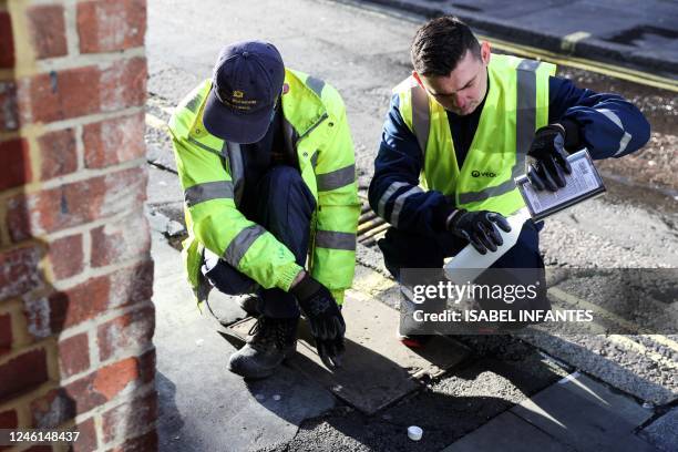 Street cleaners prepare to spray anti-pee paint on a wall in Soho, central London, on January 11, 2023. - Westminster City Council is fighting...