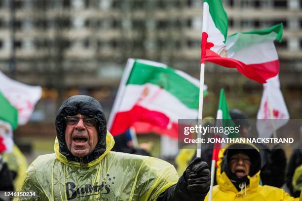 Protesters shout slogans and wave flags outside the Appeals Court building in Sollentuna, north of Stockholm, Sweden on January 11 at the start of...