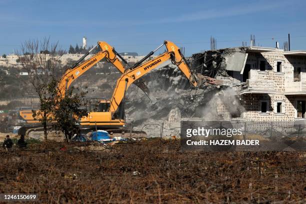 Israeli bulldozers demolish a Palestinian house, under construction without a permit from the Israeli authorities which lies in the area C , east of...