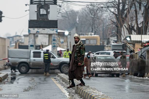 Member of Taliban security force stands guard on a blocked road after a suicide blast near Afghanistan's foreign ministry at the Zanbaq Square in...