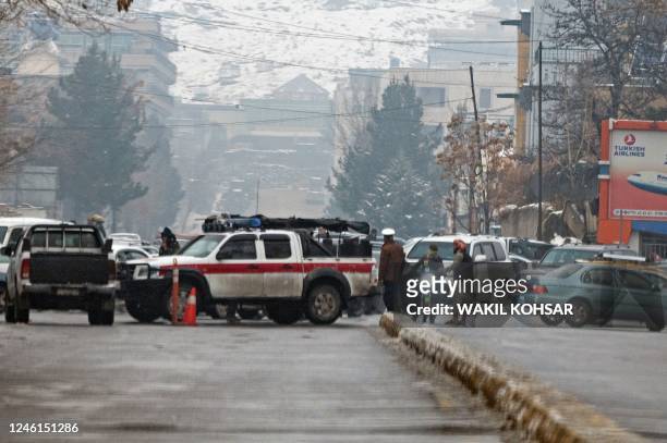 Taliban security forces block a road after a suicide blast near Afghanistan's foreign ministry at the Zanbaq Square in Kabul on January 11, 2023. - A...