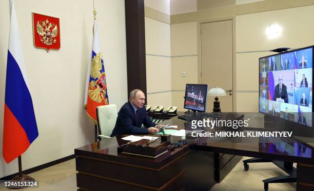 Russian President Vladimir Putin chairs a meeting with members of the government via a video conference at the Novo-Ogaryovo state residence, outside...