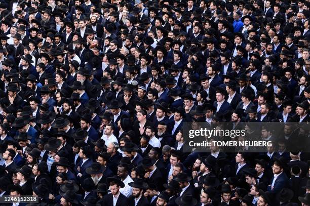 Israeli ultra-Orthodox men attend the funeral of Rabbi Shimon Baadani, in the city of Bnei Brak near Tel Aviv, on January 11, 2023. - Baadani, the...