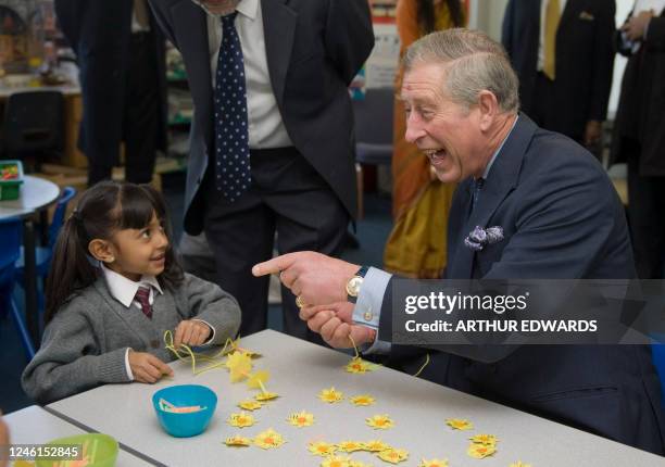 Britain's Prince Charles meets with pupils during a visit to the Swaminarayan School, in north London, on March 4 to mark the Hindu religious...