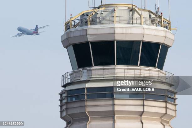 An American Airlines Airbus A319 airplane takes off past the air traffic control tower at Ronald Reagan Washington National Airport in Arlington,...