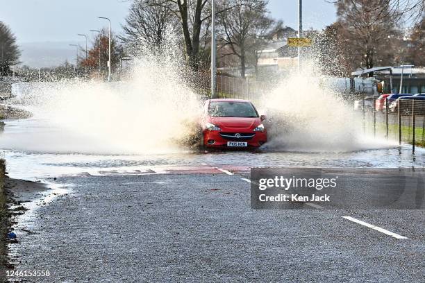 Car negotiates a stretch of lying water after many parts of Scotland experienced heavy rain, on January 11, 2023 in Inverkeithing, Scotland.