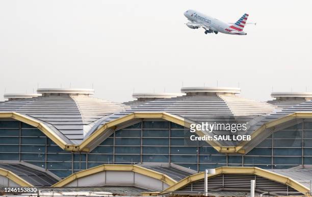 An American Airlines Airbus A319 airplane takes off past the terminal at Ronald Reagan Washington National Airport in Arlington, Virginia, January...