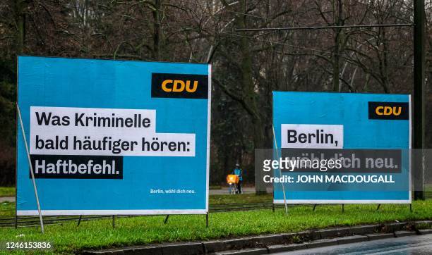 Delivery worker cycles past billboards with election campaign posters for the Christian Democratic Union CDU party in Berlin on January 11 ahead of...