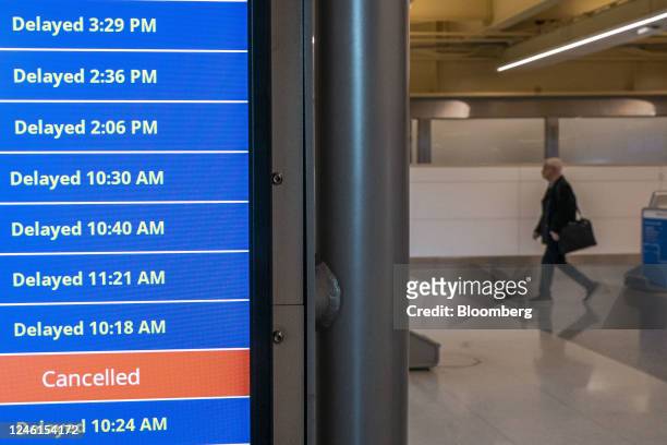 Cancelled and delayed flights on a departure board at Ronald Reagan National Airport in Arlington, Virginia, US, on Wednesday, Jan. 11, 2023. US...