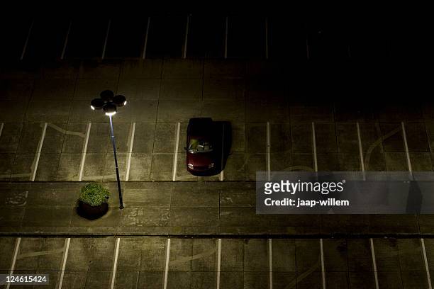 parking lot at night - thief stock pictures, royalty-free photos & images