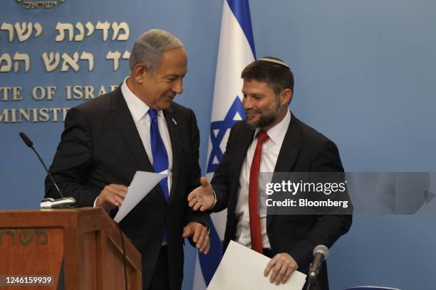 Bezalel Smotrich, Israels finance minister, greets Benjamin Netanyahu, Israel's prime minister, left, during a news conference to present a cost of...