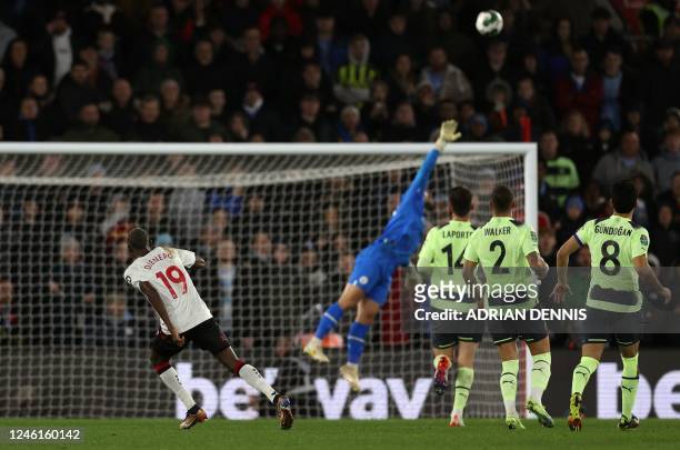 Southampton's Malian midfielder Moussa Djenepo watches the ball as he scores the team's second goal during the English League Cup quarter-final...