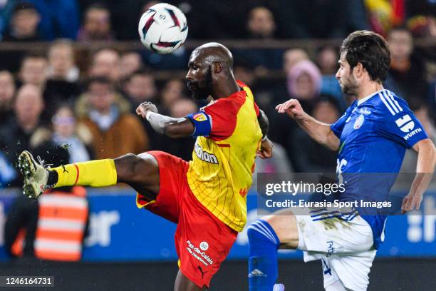 Seko Fofana of Lens passes the ball while is blocked by Sanjin Prcic of RC Strasbourg during the Ligue 1 match between RC Strasbourg and RC Lens at...