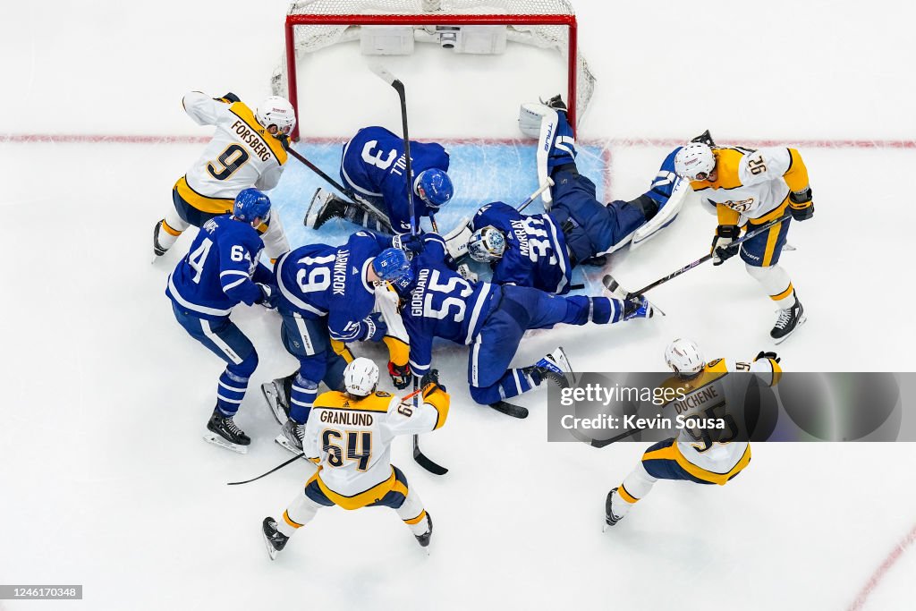 Toronto Predators Matt Murray of the Toronto Maple Leafs covers the puck as team-mates ...