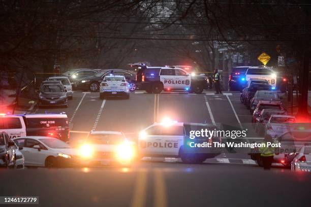 Police investigate a triple shooting in the 1400 block of Sheridan Street Northwest near a Metro bus in Washington, DC on January 11, 2023. Two...