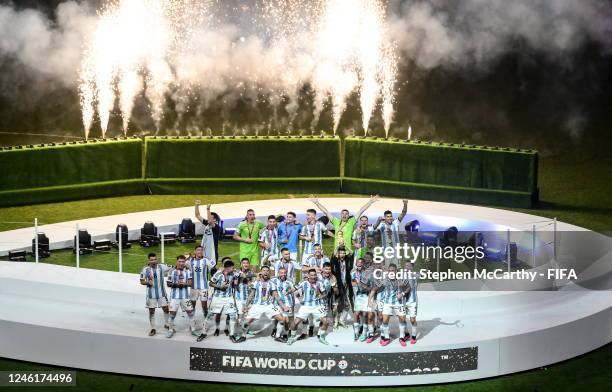 Argentina players celebrate with the FIFA World Cup trophy following the FIFA World Cup Qatar 2022 Final match between Argentina and France at Lusail...