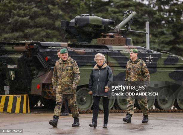 German Defence Minister Christine Lambrecht walks with the commander of the armored infantryman batallion 371, lieutenant Thomas Spranger , past an...