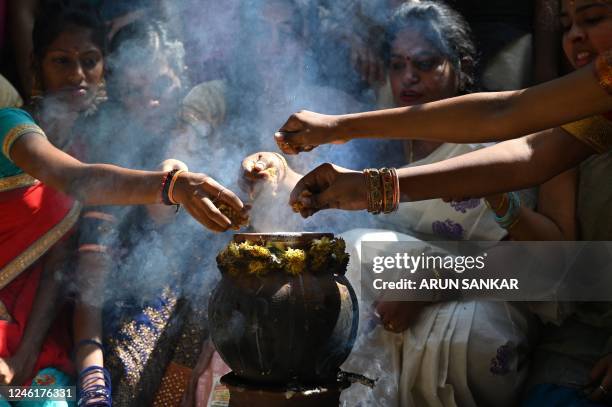Students prepare sweet pongal during celebrations for 'Pongal', the Tamil harvest festival, at a college in Chennai on January 12, 2023.