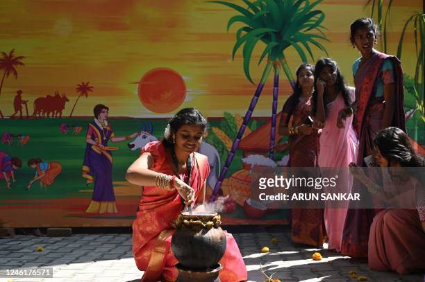 Students prepare sweet pongal during celebrations for 'Pongal', the Tamil harvest festival, at a college in Chennai on January 12, 2023.