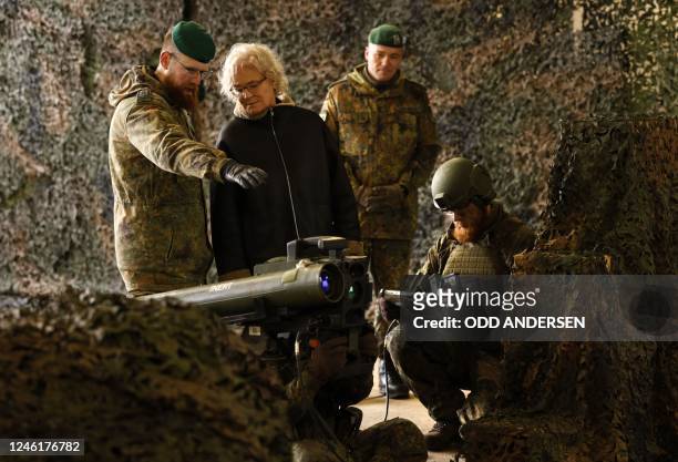 German Defence Minister Christine Lambrecht listens to explanations about the anti tank system MELLS that is used wit the armoured "Marder" vehicle,...