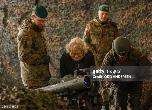 German Defence Minister Christine Lambrecht listens to explanations about the anti tank system MELLS that is used wit the armoured "Marder" vehicle,...