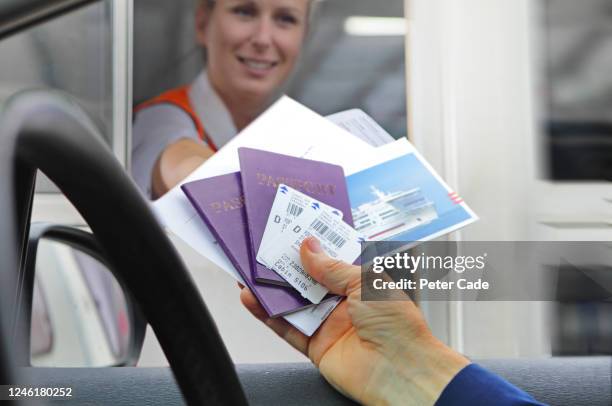 handing over tickets and passports to board boat - uk passport stock pictures, royalty-free photos & images