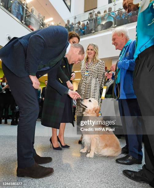 Prince William, Prince of Wales and Catherine, Princess of Wales meet Therapy Dog Golden retriever 'Rosie' as they visit the Royal Liverpool...