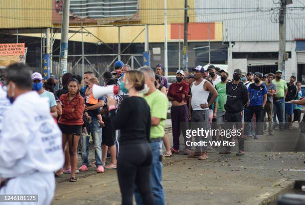 Members of 'Pescador de Hombres' foundation bring food to Venezuelans stranded in a makeshift camp amid Covid-19 pandemic, waiting for an opportunity...