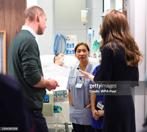 Prince William, Prince of Wales and Catherine, Princess of Wales meet health care assistant Anne O'Hara in the intensive care ward during a visit to...