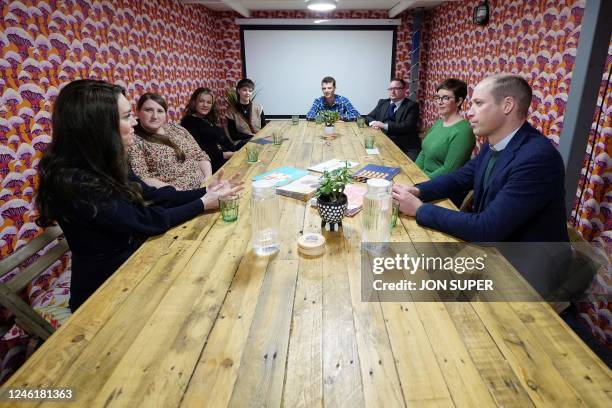 Britain's Prince William , Prince of Wales, and Britain's Catherine , Princess of Wales, meet with staff during a visit to the Open Door Charity, a...