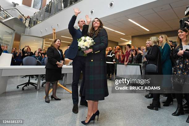 Britain's Prince William , Prince of Wales, and Britain's Catherine , Princess of Wales, wave at staff during a visit to the Royal Liverpool...