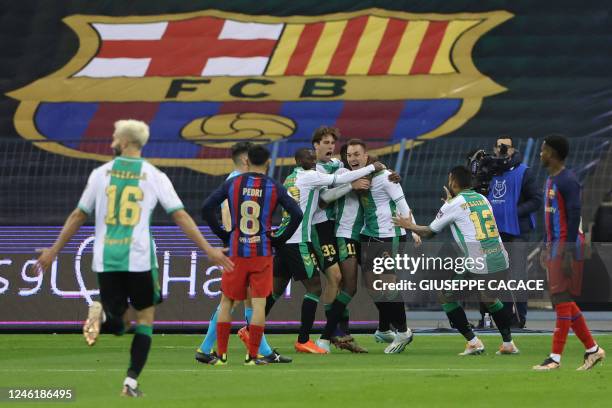 Betis players celebrate their second goal scored by Real Betis' Spanish forward Lorenzo Moron during the Spanish Super Cup semi-final football match...