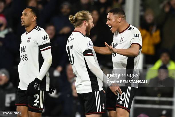 Fulham's Brazilian striker Carlos Vinicius celebrates with Fulham's US defender Tim Ream after scoring their second goal during the English Premier...