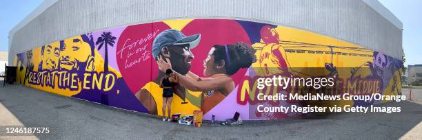 Artist Mikala Taylor finishes part of a Kobe Bryant mural on the side of ASHE Society cannabis dispensary in Santa Ana, CA on Monday, August 24,...
