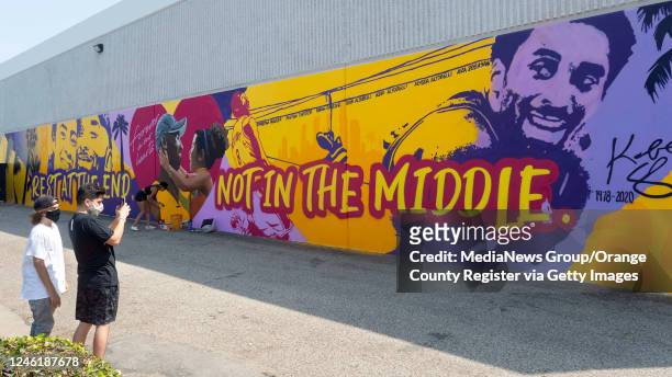 Visitors take photos at a Kobe Bryant mural on the side of ASHE Society cannabis in Santa Ana, CA on Monday, August 24, 2020. The Orange County Board...