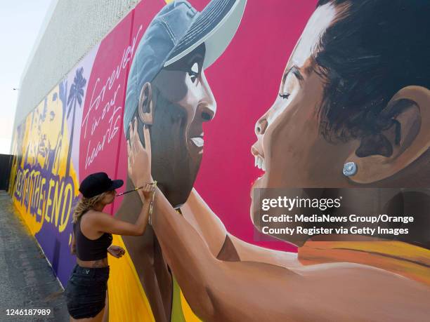 Artist Mikala Taylor finishes part of a Kobe Bryant mural on the side of ASHE Society cannabis in Santa Ana, CA on Monday, August 24, 2020. Taylor,...