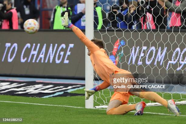 Barcelona's German goalkeeper Marc-Andre ter Stegen dives to save the ball during the penalties shootout during the Spanish Super Cup semi-final...