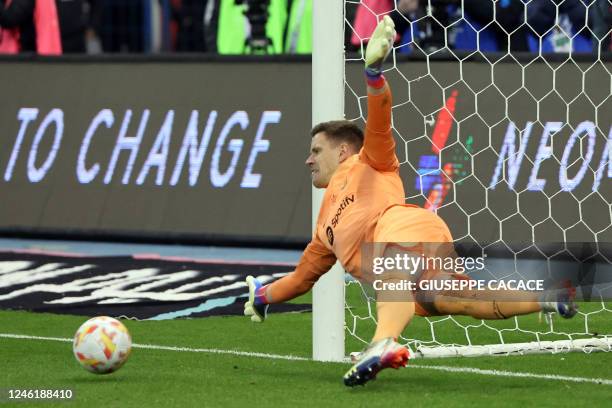 Barcelona's German goalkeeper Marc-Andre ter Stegen dives to save the ball during the penalties shootout during the Spanish Super Cup semi-final...