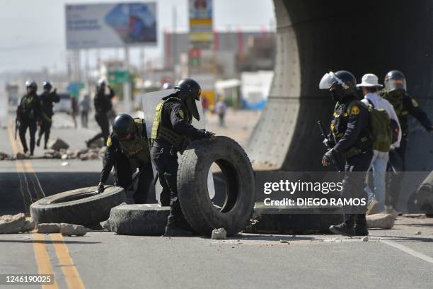 Policemen patrol the Pan-American highway at La Joya as demonstrators hold a blockade to demand the resignation of Peruvian President Dina Boluarte...