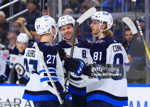 Josh Morrissey of the Winnipeg Jets celebrates his second period goal with Kyle Connor and Nikolaj Ehlers during an NHL game against the Buffalo...