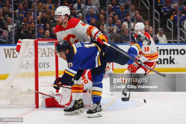 Brayden Schenn of the St. Louis Blues shoots the puck against Rasmus Andersson of the Calgary Flames in the first period at Enterprise Center on...
