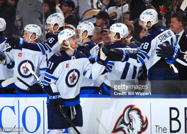 Kyle Connor of the Winnipeg Jets celebrates his third period goal at the bench during an NHL game against the Buffalo Sabres on January 12, 2023 at...