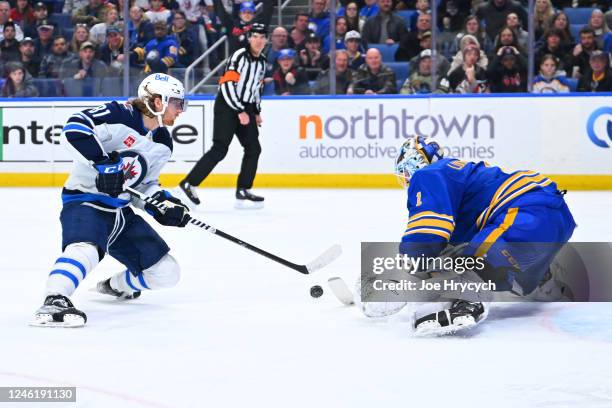 Kyle Connor of the Winnipeg Jets scores a third period goal against Ukko-Pekka Luukkonen of the Buffalo Sabres during an NHL game on January 12, 2023...