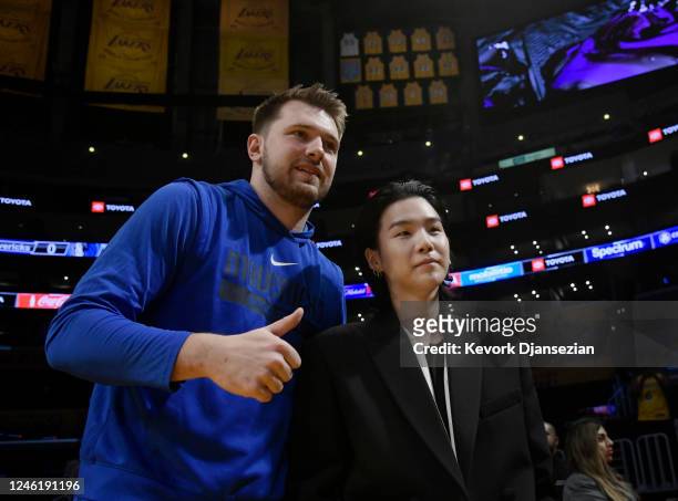 Luka Doncic of the Dallas Mavericks poses with Suga, a member of the South Korean band BTS, before the game between the Los Angeles Lakers and Dallas...