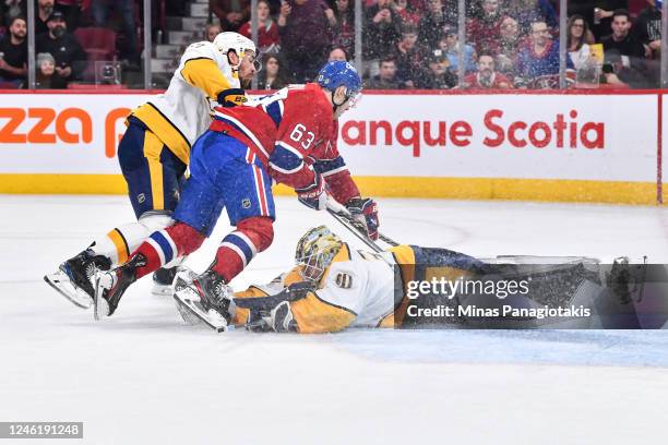 Goaltender Yaroslav Askarov of the Nashville Predators makes a save in his first career NHL game against Evgenii Dadonov of the Montreal Canadiens...