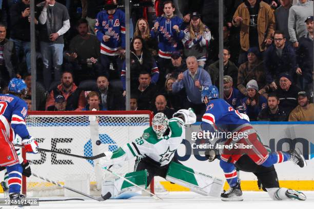 Adam Fox of the New York Rangers shoots and scores in overtime to give the Rangers a 2-1 win against Jake Oettinger of the Dallas Stars at Madison...