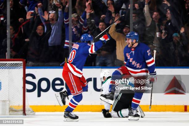 Adam Fox and Artemi Panarin of the New York Rangers celebrate after a goal in overtime against the Dallas Stars at Madison Square Garden on January...