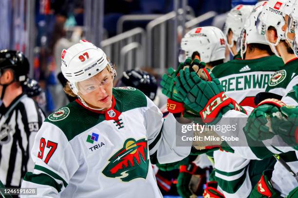 Kirill Kaprizov of the Minnesota Wild is congratulated by his teammates after scoring a goal against the New York Islanders during the third period...